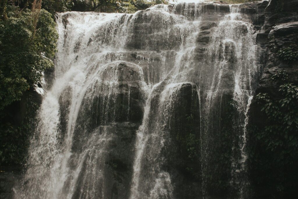 A cascading waterfall flows over mossy rocks